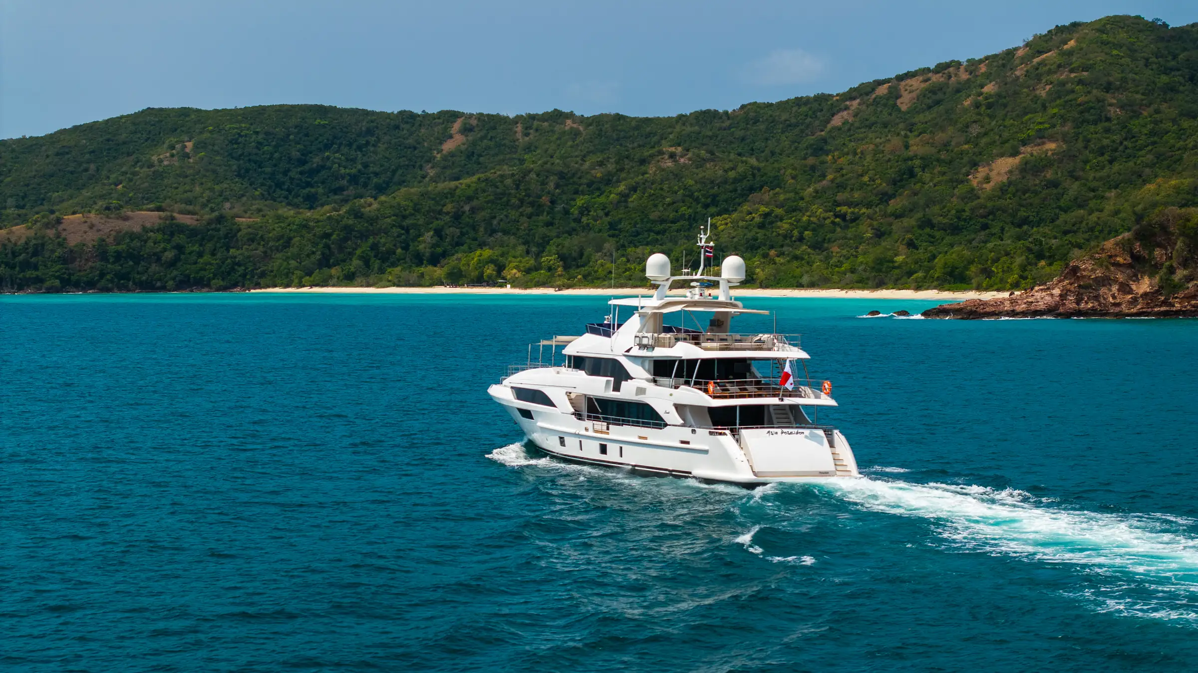 Asia Poseidon under way, a beach on the horizon behind her